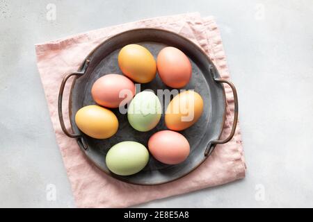 Easter eggs in vintage tray and one cracked egg in the middle Stock Photo
