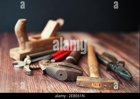 Dirty set of vintage hand tools on wooden background Stock Photo