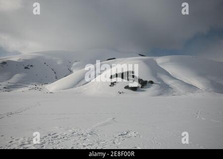 Panoramic view of Pian Grande covered by snow in the national park of Monti Sibillini during winter day Stock Photo