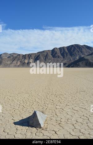sailing rock leaving a long trail in the desert of the Racetrack Playa marks the path of one of the mysterious moving rocks in the Death Valley Nation Stock Photo