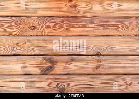 Old wood wall of yellow fresh plank with characteristic fibers and texture highlighted, background and texture, copy space. Stock Photo