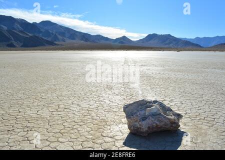 sailing rock leaving a long trail in the desert of the Racetrack Playa marks the path of one of the mysterious moving rocks in the Death Valley Nation Stock Photo