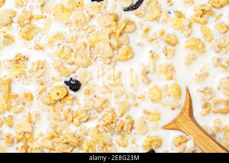 Healthy morning breakfast of muesli with milk and raisins. Top view. Healthy eating. Stock Photo
