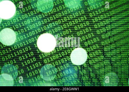An illustration of green binary code on bokeh background Stock Photo