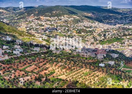 Aerial view of Ajloun town from Rabad castle, Jordan. Ajloun is a hilly town in the north of Jordan famous for its impressive castle ruins Stock Photo