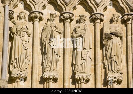 Statues of Saints Lucy, Agatha, Agnes and Cecilia on the West Front of Salisbury Cathedral, Wiltshire. Sculpted by James Redfern in 1867 and on public Stock Photo