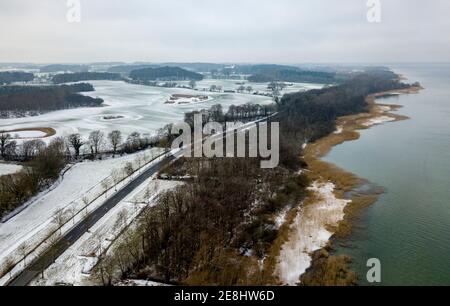 Bellin, Germany. 31st Jan, 2021. The fields on the shore of Lake Selenter in Ostholstein are covered by a thin layer of snow. (Aerial view with drone) Credit: Axel Heimken/dpa/Alamy Live News Stock Photo