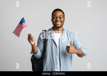 Happy black man showing thumb up and american flag Stock Photo