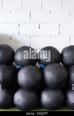 Set of sports equipment with fitness ball on floor near color wall ...