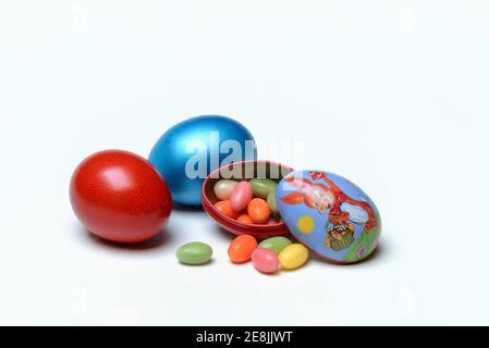 Easter eggs and sugar eggs in tin egg with rabbit figure Stock Photo