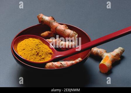 Turmeric powder and turmeric root, curcuma longa, turmeric root, turmeric powder Stock Photo