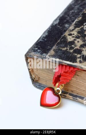 Heart on tape in old book Stock Photo