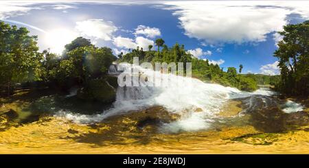 Cascade of Aliwagwag Falls in green forest, aerial drone. Waterfall in the tropical mountain jungle. Philippines, Mindanao. 360 panorama VR. Stock Photo