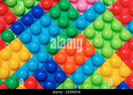 Children's multi-colored constructor as an abstract background. Multicolored blocks close-up. Stock Photo
