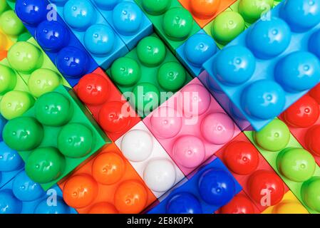 Children's multi-colored constructor as an abstract background. Multicolored blocks close-up. Stock Photo