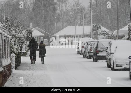 two people walking in the snow Stock Photo