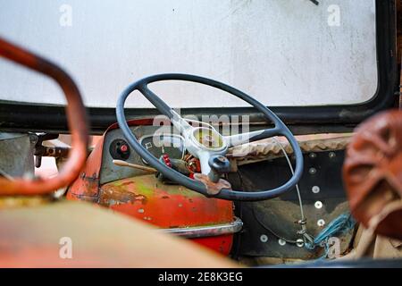 Close up of a cabin of a very old red tractor Stock Photo