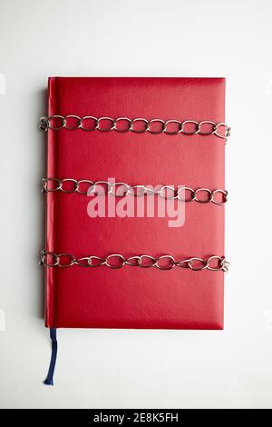 red empty book or diary in chains. information security concept. top view Stock Photo