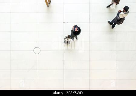 top view of man on cell phone wearing use flag wooden hat in the oculus NYC Stock Photo