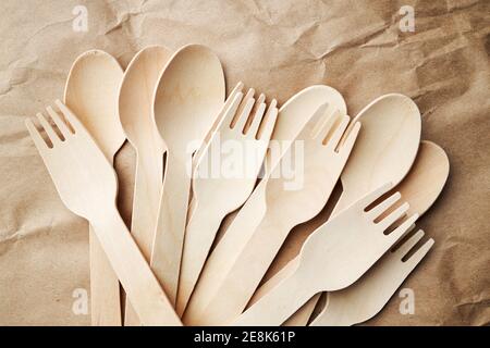 eco friendly disposable kitchenware utensils on paper background. look from above. wooden forks and spoons. eco friendly concept Stock Photo