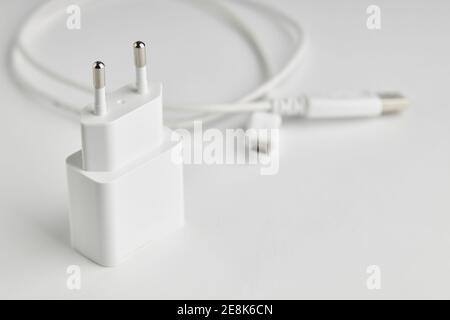 white usb charge or power adapter with usb wire at background. charging portable information devices Stock Photo