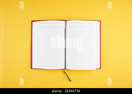open diary with white pages over yellow background. mockup for decor or design. top view Stock Photo