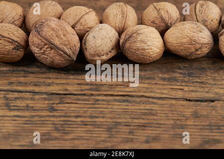 group of walnuts on a wooden board background Stock Photo