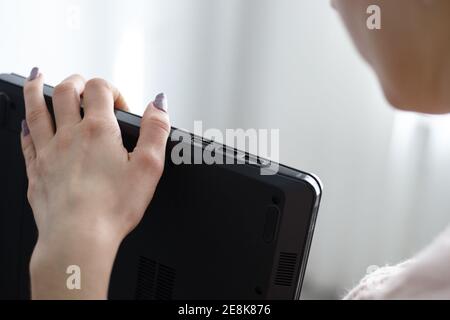 female person looking to laptop interfaces. close up usb ports and hdmi video port. check laptop Stock Photo