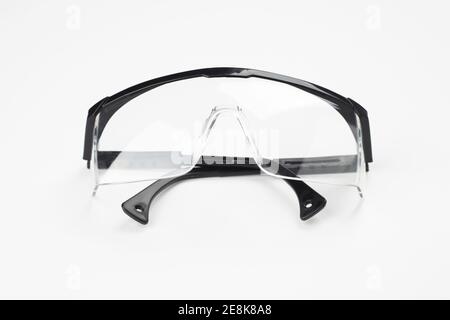 black plastic protection glasses isolated on white background. protection workwear concept Stock Photo