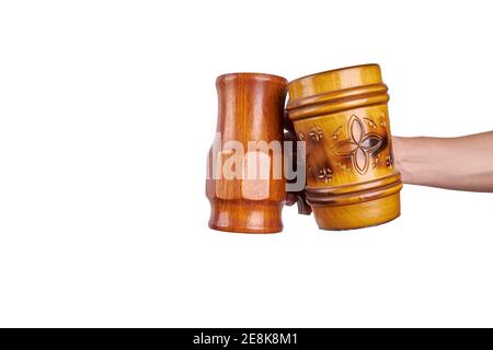 a wooden beer mugs in hand isolated on a white background Stock Photo