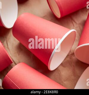 pile of disposable red paper cups on paper background. eco friendly concept. look from above. background backdrop Stock Photo