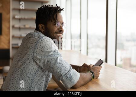 Stylish young black guy enjoy weekend at home with smartphone Stock Photo