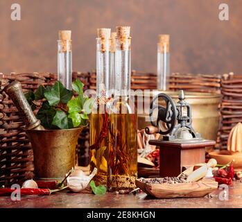 Still life with olive oil and old kitchen utensils on a brown background. Stock Photo
