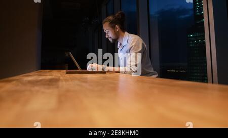 Busy millennial black employee work in office until late night Stock Photo