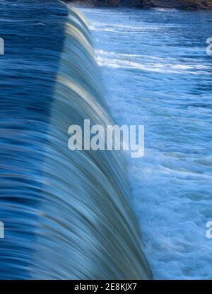 Winter close up view of water flowing over a weir on the River Wharfe in Yorkshire Stock Photo