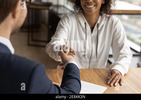Smiling african woman handshaking get acquainted with young male realtor Stock Photo