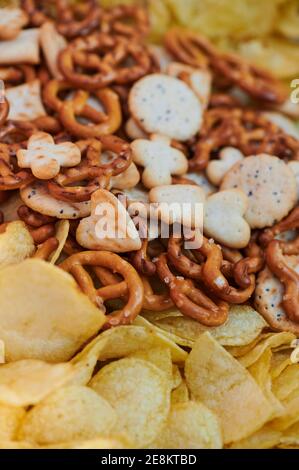 close up of a snack variety like pretzel and potato chips Stock Photo
