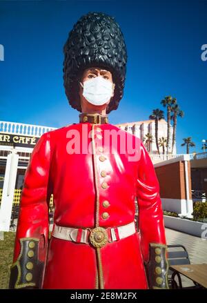 An ornamental soldier wearing a surgical mask outside a cafe in  Torrox Costa, Costa del Sol, Malaga Province, Andalucia, Spain Stock Photo