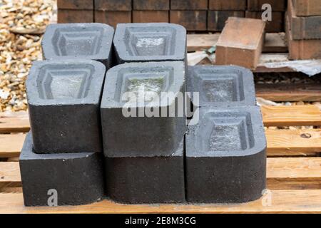 Close up of Charcoal Key Kerbs on a pallet at a Builders Merchants in England, UK Stock Photo