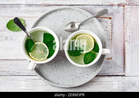 Two cups of hot mint tea with lemon. Stock Photo