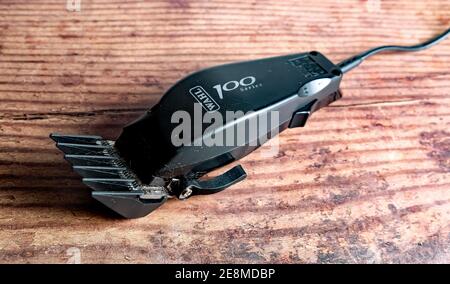 Norwich, Norfolk, UK – December 19 2020. An illustrative photo of a set of Wahl 100 electric hair clippers on a wooden floor Stock Photo