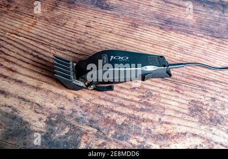 Norwich, Norfolk, UK – December 19 2020. An illustrative photo of a set of Wahl 100 electric hair clippers on a wooden floor Stock Photo