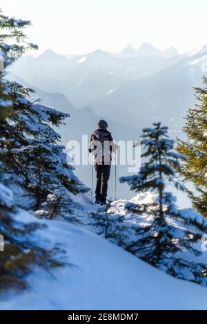 female hiker in beautiful snow covered mountains Stock Photo