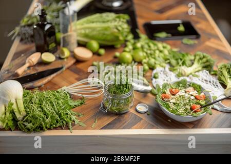 Healthy food on kitchen with woman on background Stock Photo