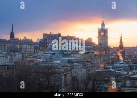 Classic cityscape view of Edinburgh old town skyline, Balmoral Clock Tower and Edinburgh Castle from Calton Hill with a dramatic sunset in the capital Stock Photo