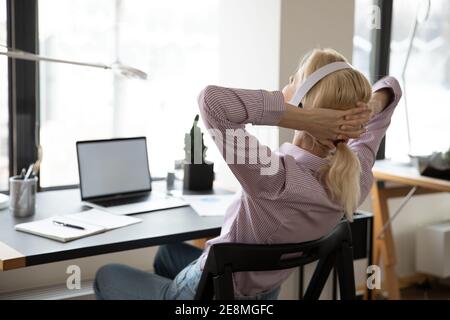 Office employee resting on chair, enjoying work break Stock Photo