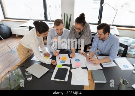 Diverse team of professionals analyzing marketing research Stock Photo