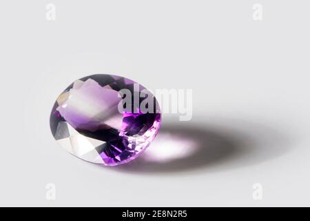 Large polished amethyst gemstone close-up on white background Stock Photo