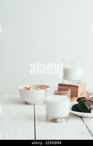 Milk in a glass, marshmallows and crackers on a white background. Stock Photo