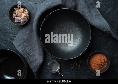An empty black plate on a black background. Top view. Stock Photo